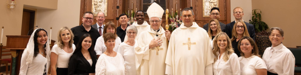 Photo of Parishners along side of Fr. Steve, Fr. Vincent and Most Reverend George Leo Thomas, Ph. D in front of the alter in the church.